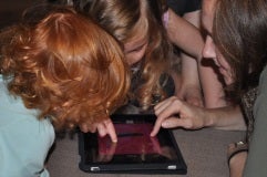 photo of kids playing on an ipad