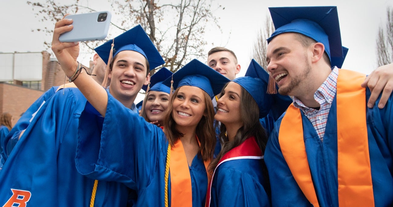 group of students taking selfie at graduation