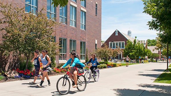 Students biking through campus