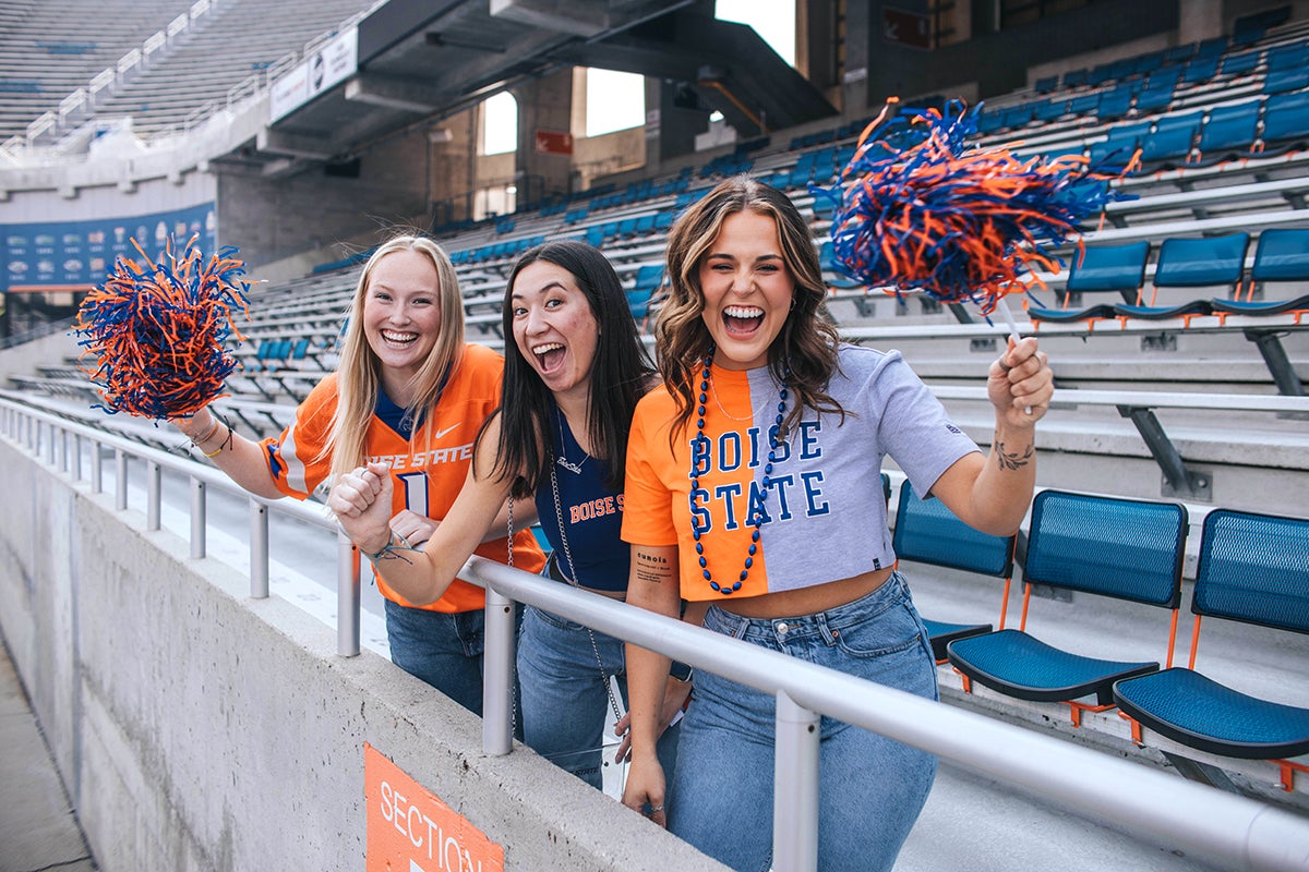 Students cheer with merch from the Bronco Shop