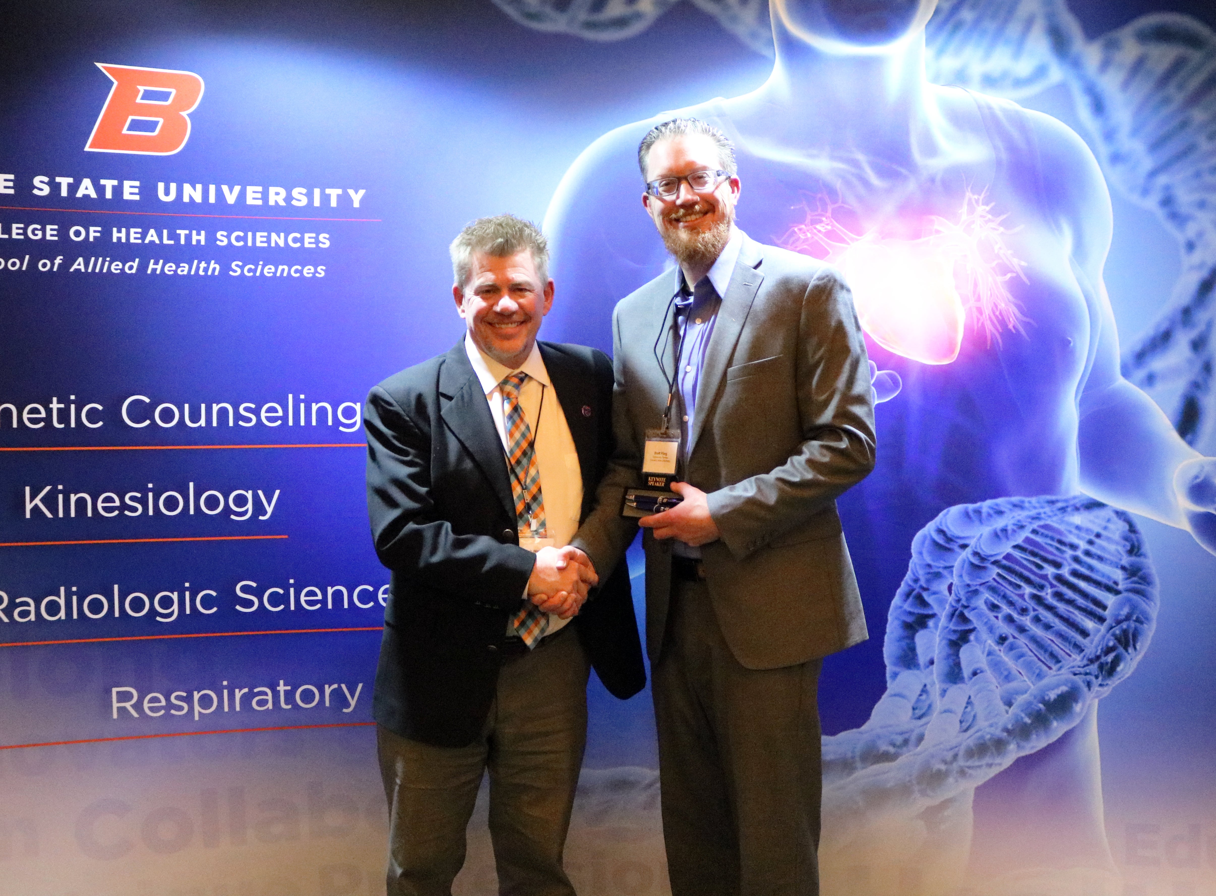 Dr. Bob Wood and Dr. Brett Fling shake hands