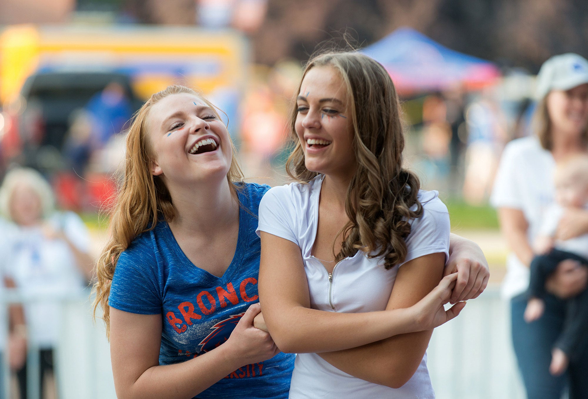 Boise State female graduates hugging each other at a party