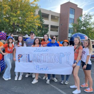 Board members spread the word at the Homecoming Parade.