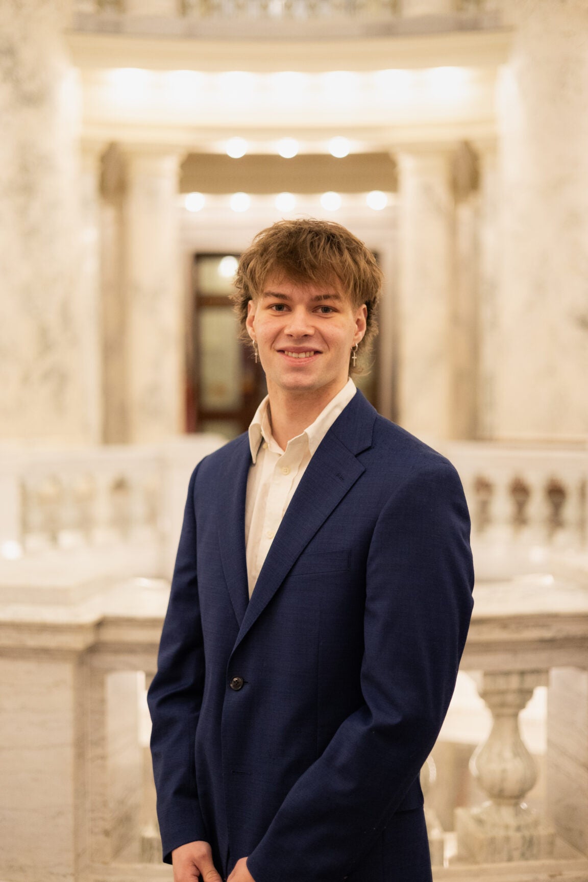 Vandel Birkenfeld standing in the Idaho Capitol Rotunda, smiling