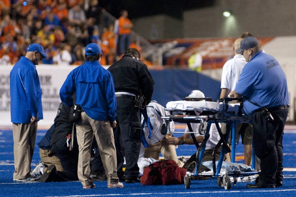 Football vs. Toledo, Homecoming, MAT students rush the field to help player