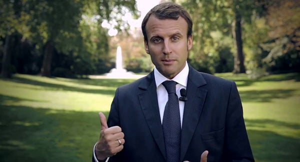 Emanuel Macron standing outdoors