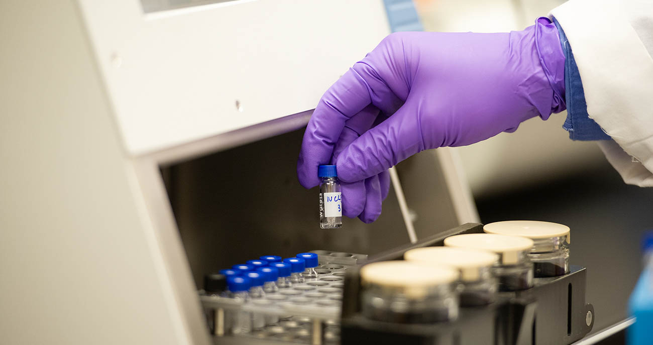 Stock Photo of a Researcher pulling lab samples out of a container
