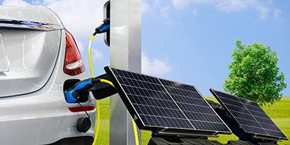 Image of an electric car being charged by plugging into solar panels