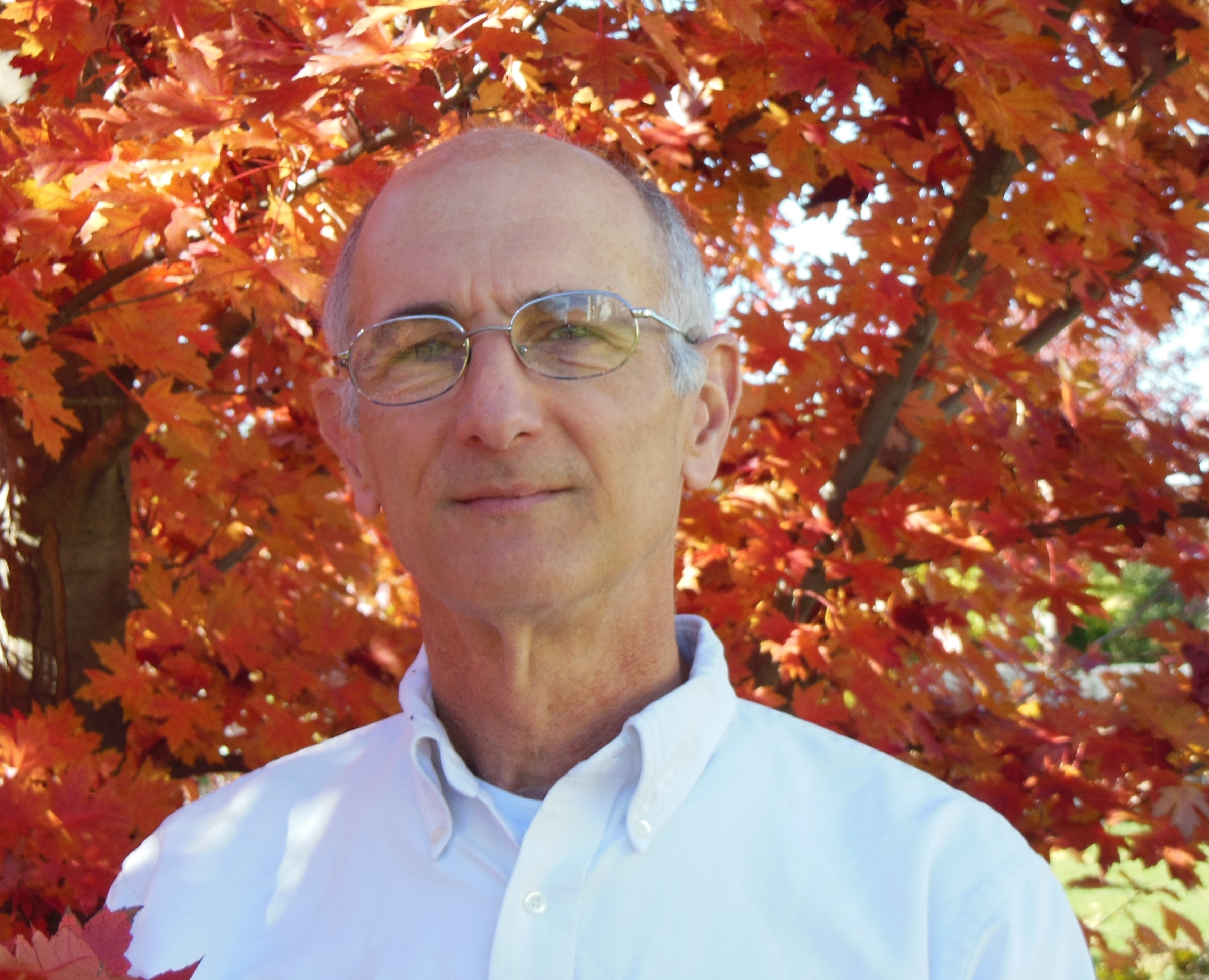 David in front of a tree during the fall season.