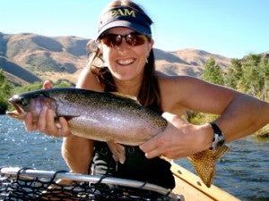Jennifer Forbey, PhD, Boise State Biological Sciences with a large rainbow trout