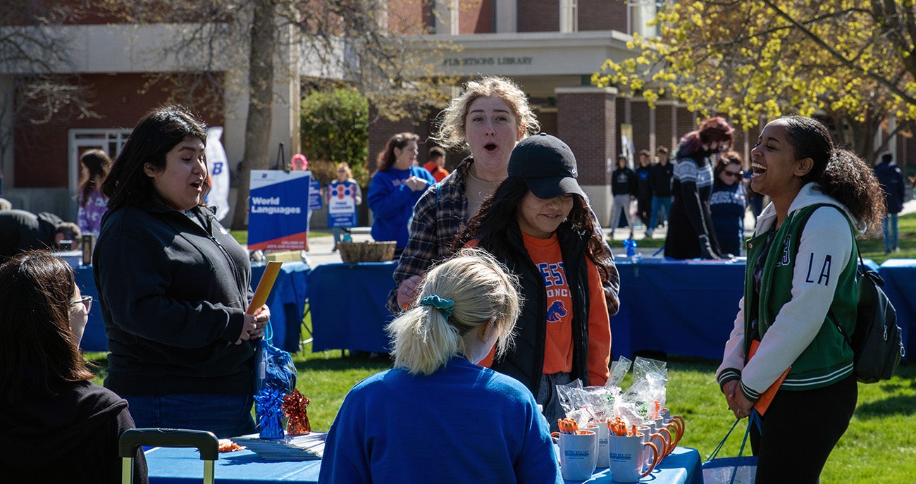Students checking out the College of Arts and Sciences at Bronco Day in April 2022