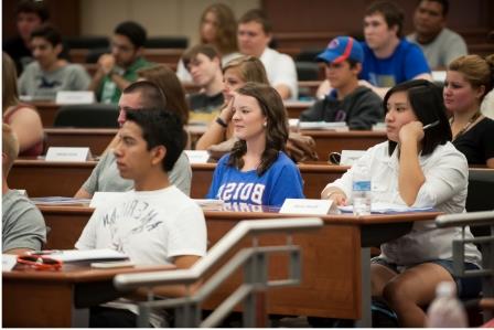 Students participating in class held in a lecture hall
