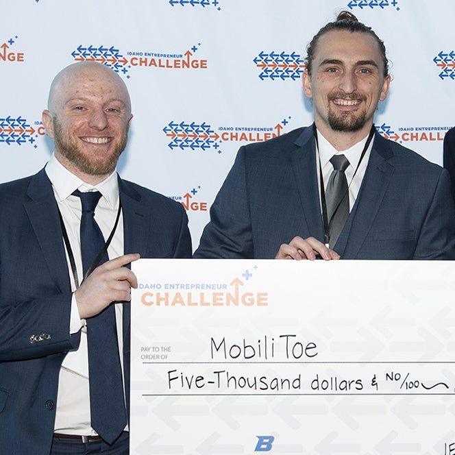 Student poses for Idaho entrepreneur challenge award