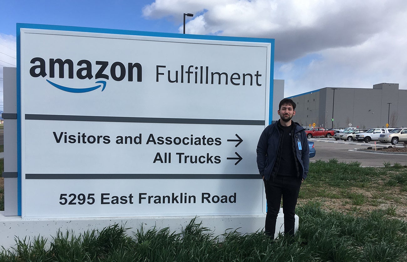 Patrick McCuistion by the sign to Amazon Fulfillment Center