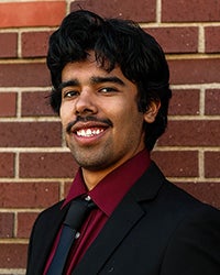 Picture of sales club officer David Morales against a brick wall.