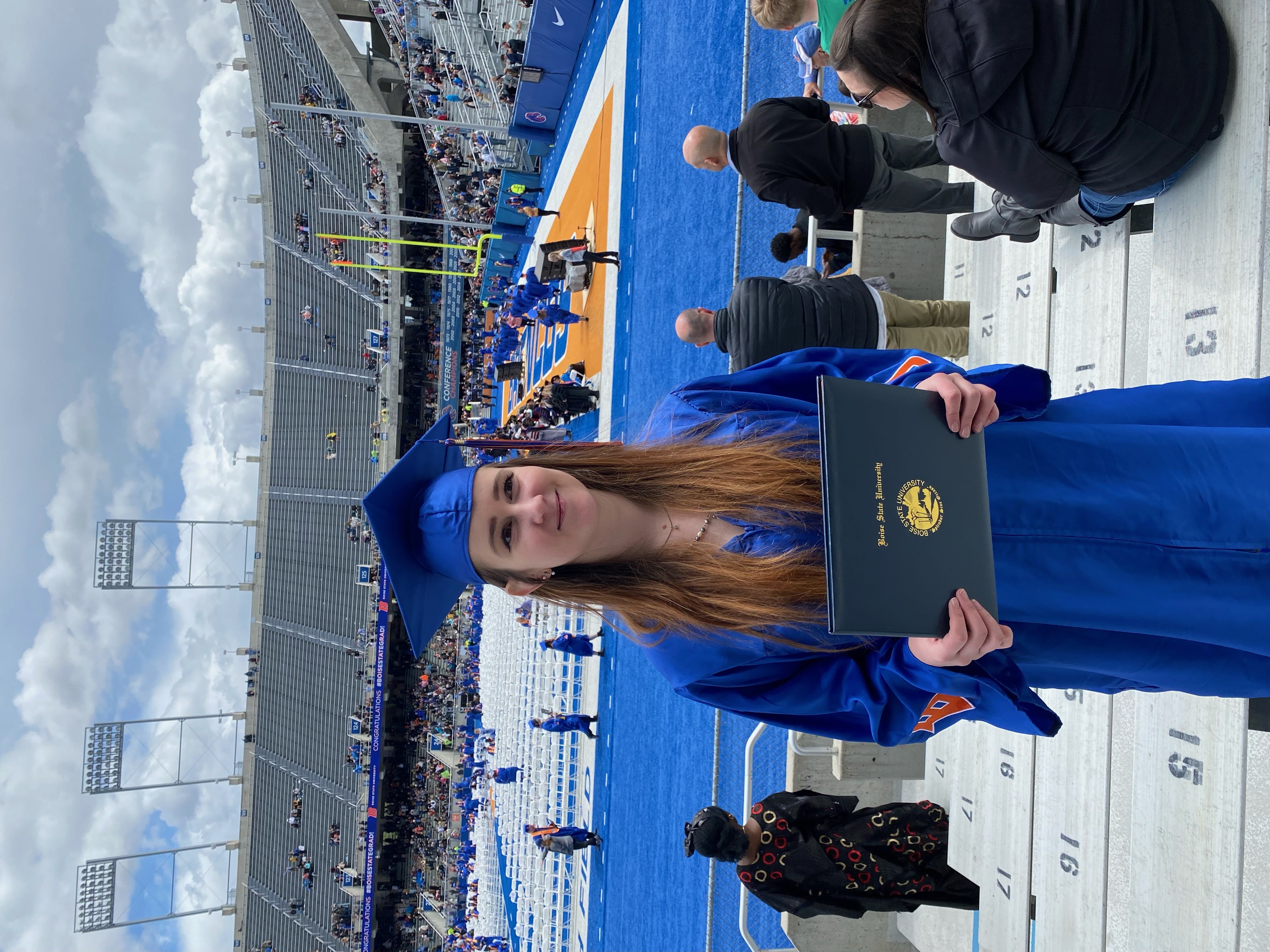 Boise State graduate near football field