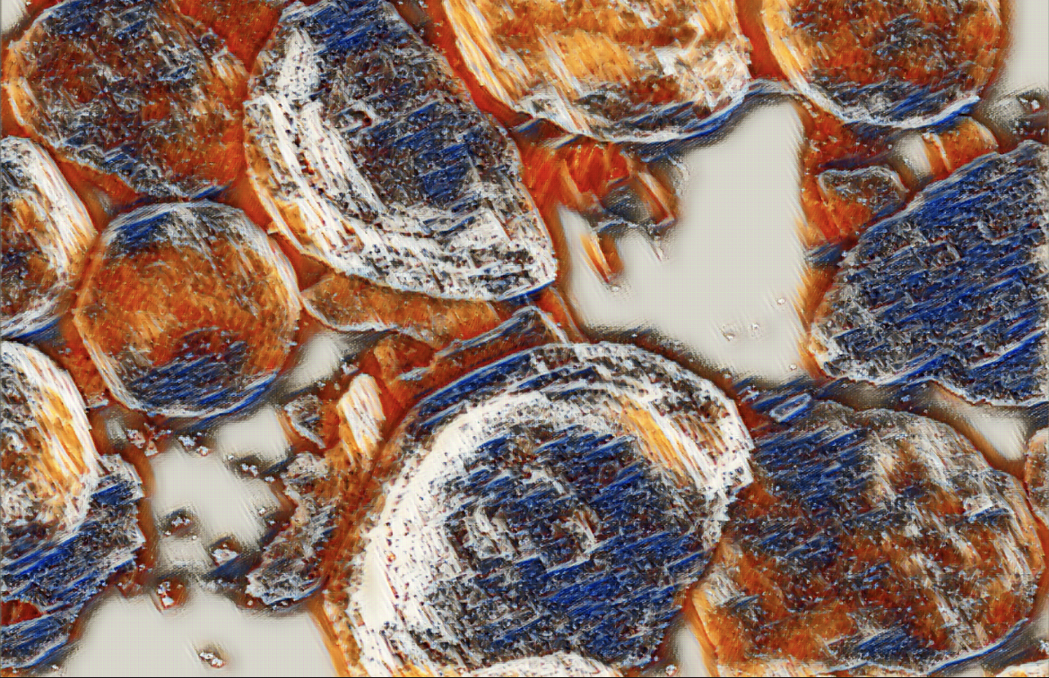 Close-up of textured, multi-colored rock fragments (orange, blue, white) against a light background