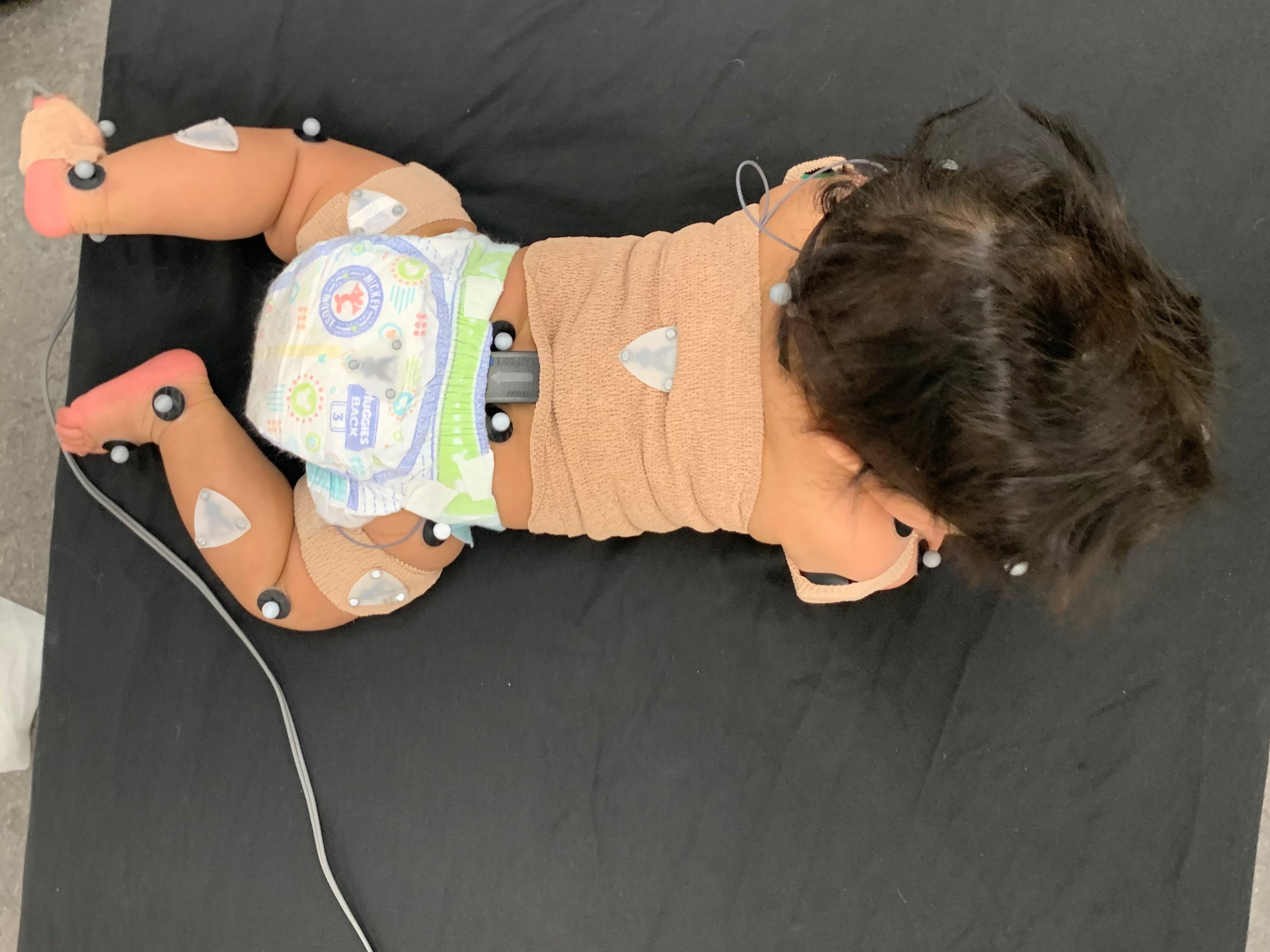 Baby on stomach hooked up to monitors