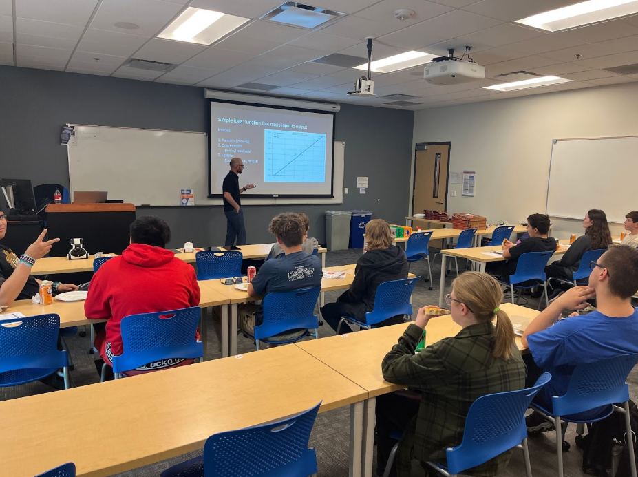 Students sitting in a classroom listening to a presentation.