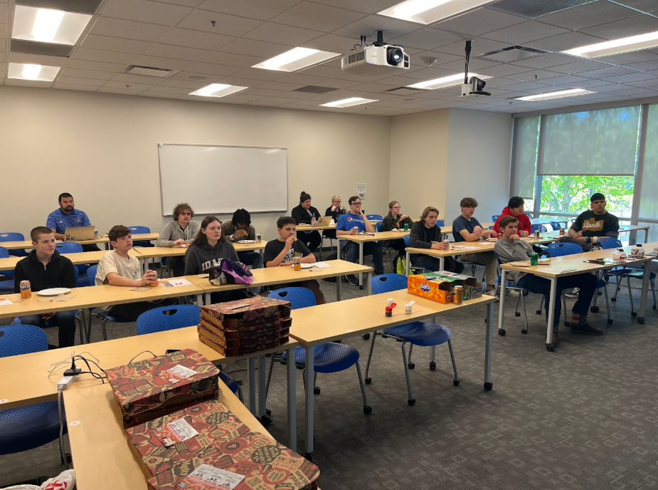 Students sitting in a classroom listening to a presentation.