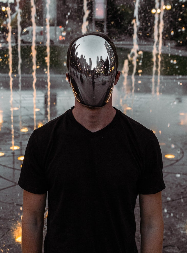 man wearing a solid reflective facepiece