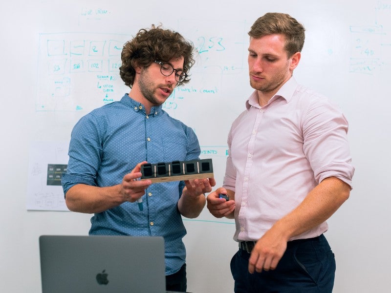 two engineers discussing a prototype
