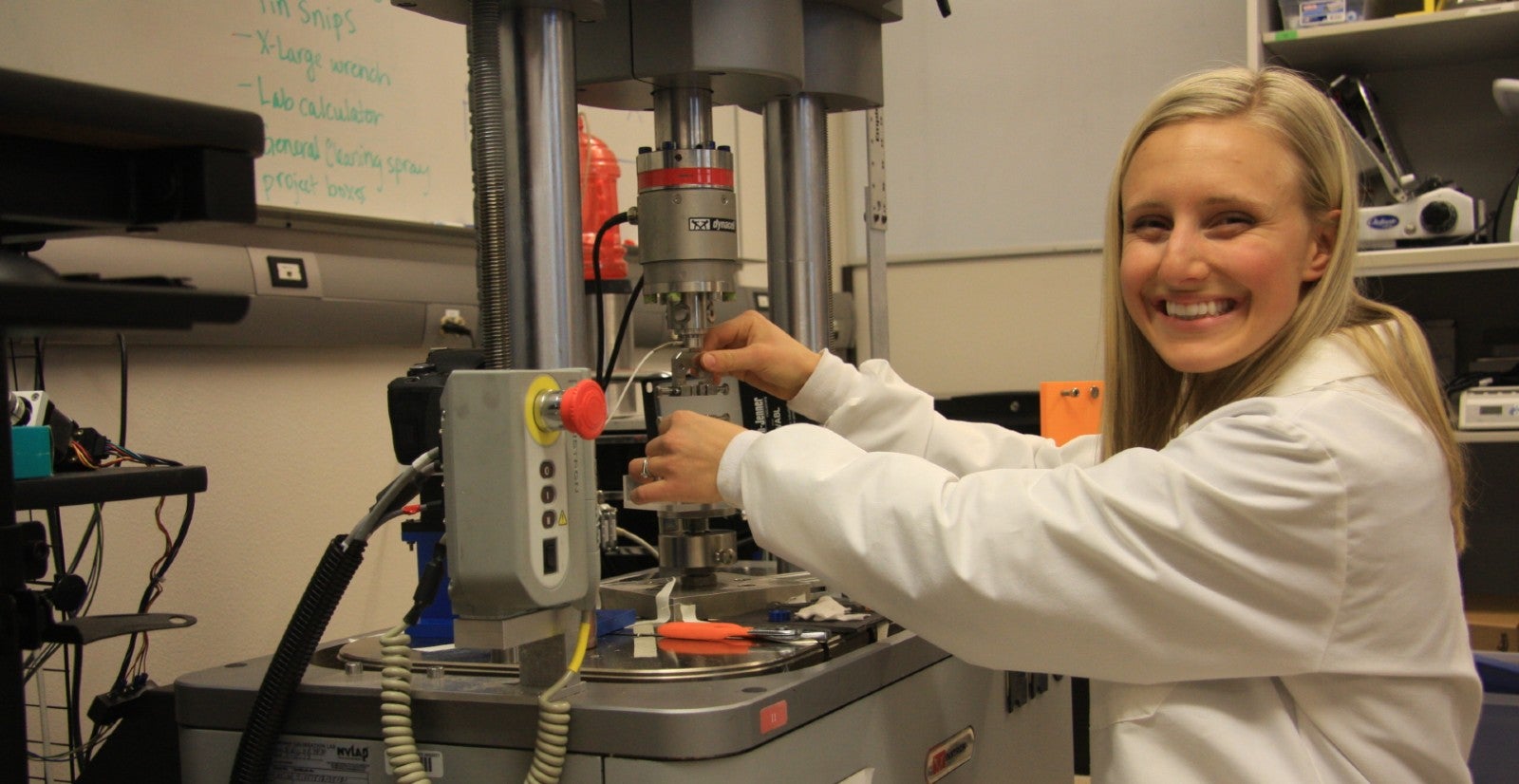 a female student places a biosample for strength testing