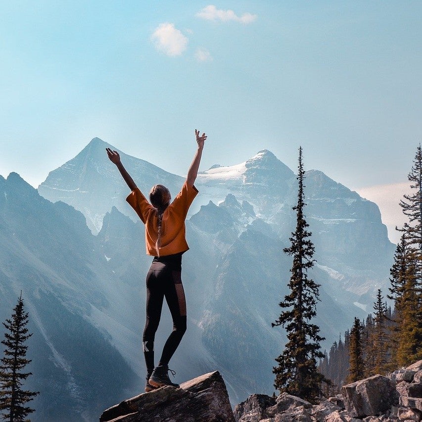 person standing in the mountains