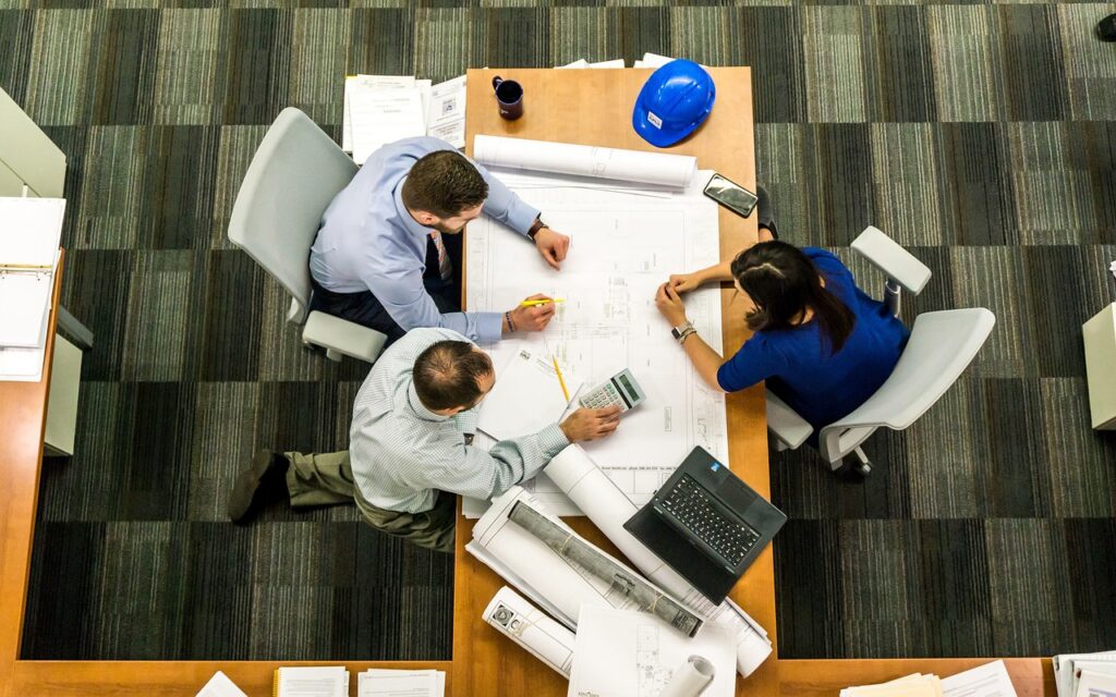 overhead view of three people working at a table