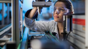 An engineer in a lab wearing safety glasses. 