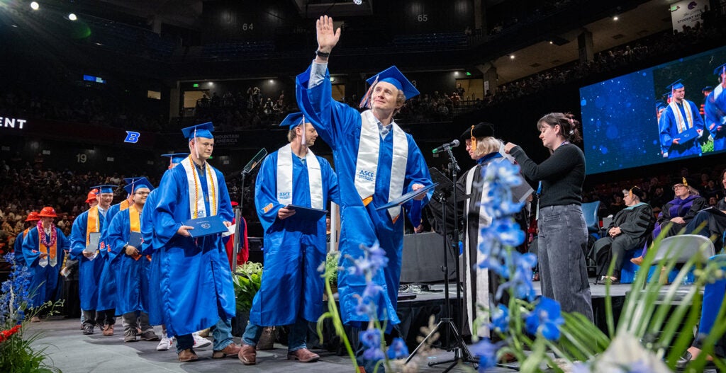 A civil engineering graduate walks the stage after receiving his diploma during the Spring 2025 commencement.