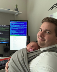 Damyn Chipman, Computing PhD student, holding his second newborn child
