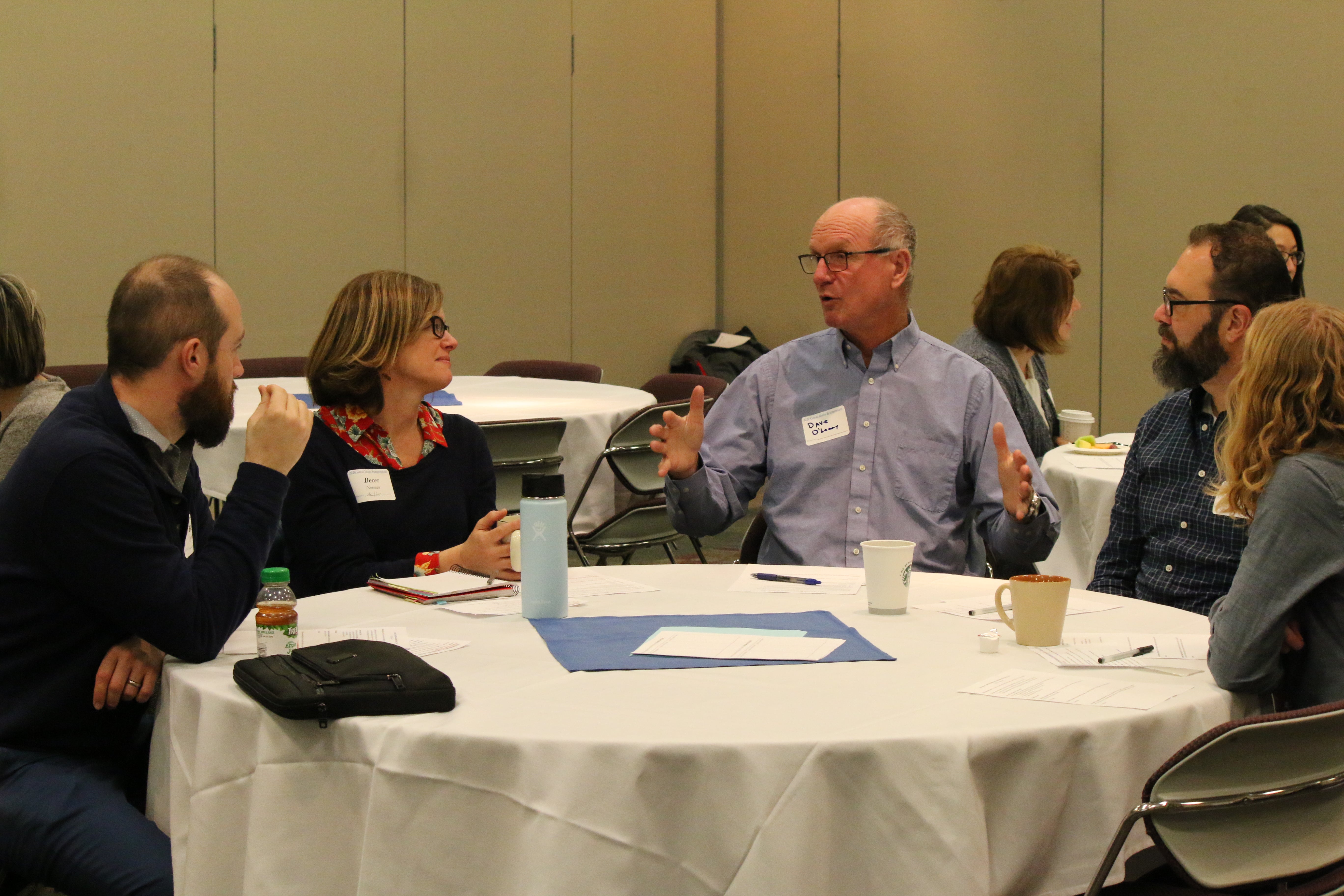 Faculty at Boise State seated at a table, discussing teaching practices