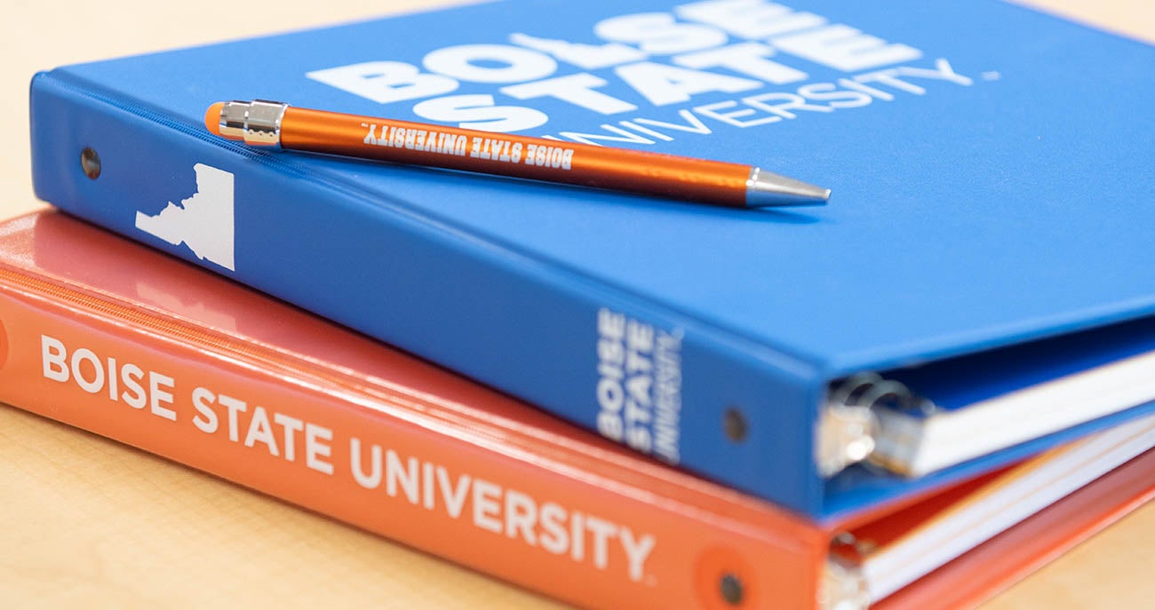 Stack of orange and blue notebooks