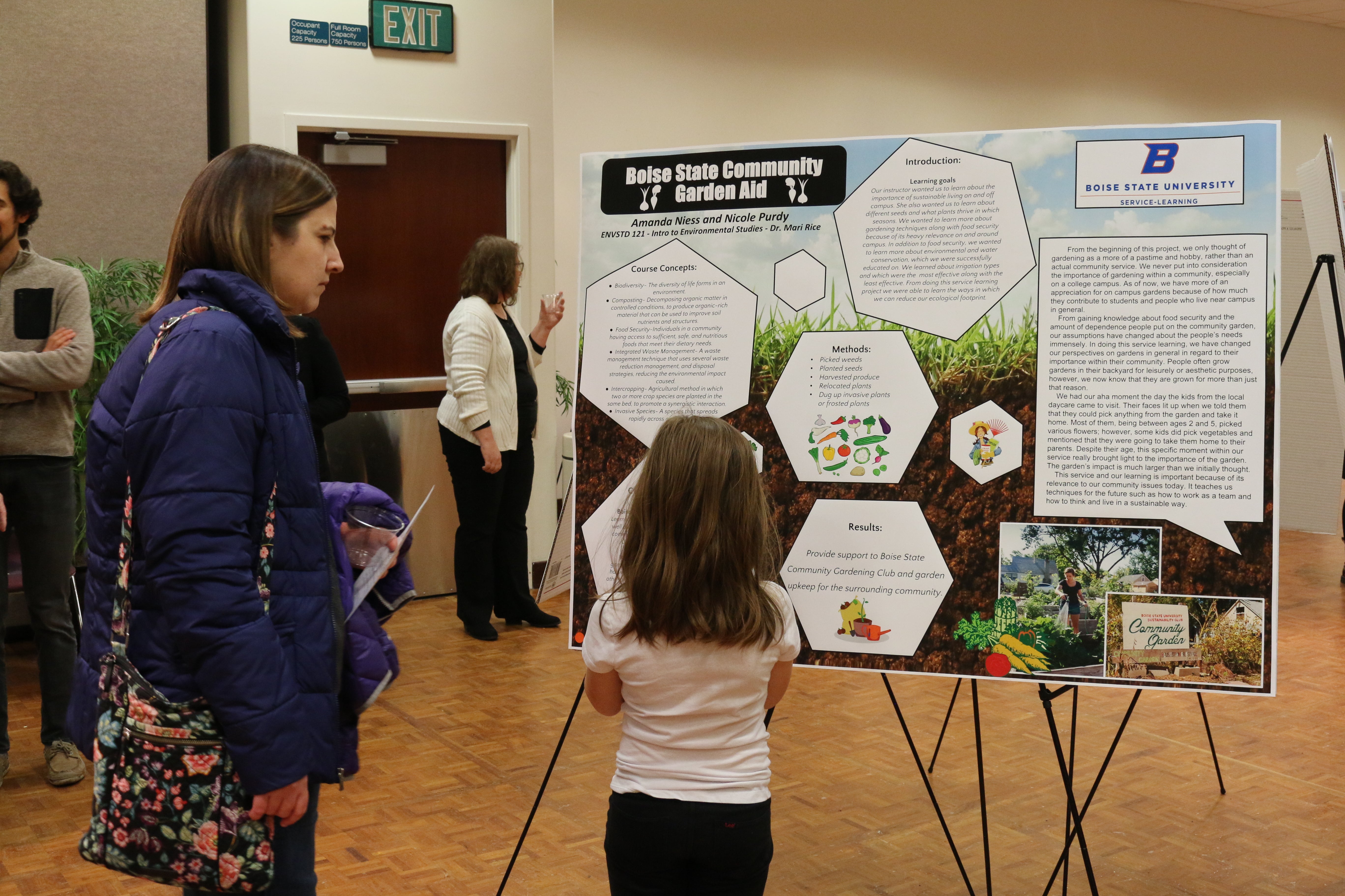 Members of the community observe a service learning project