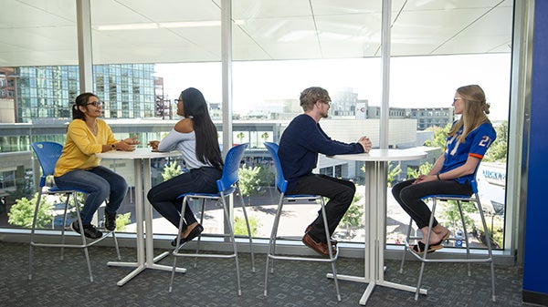students sit at tables in the city center building