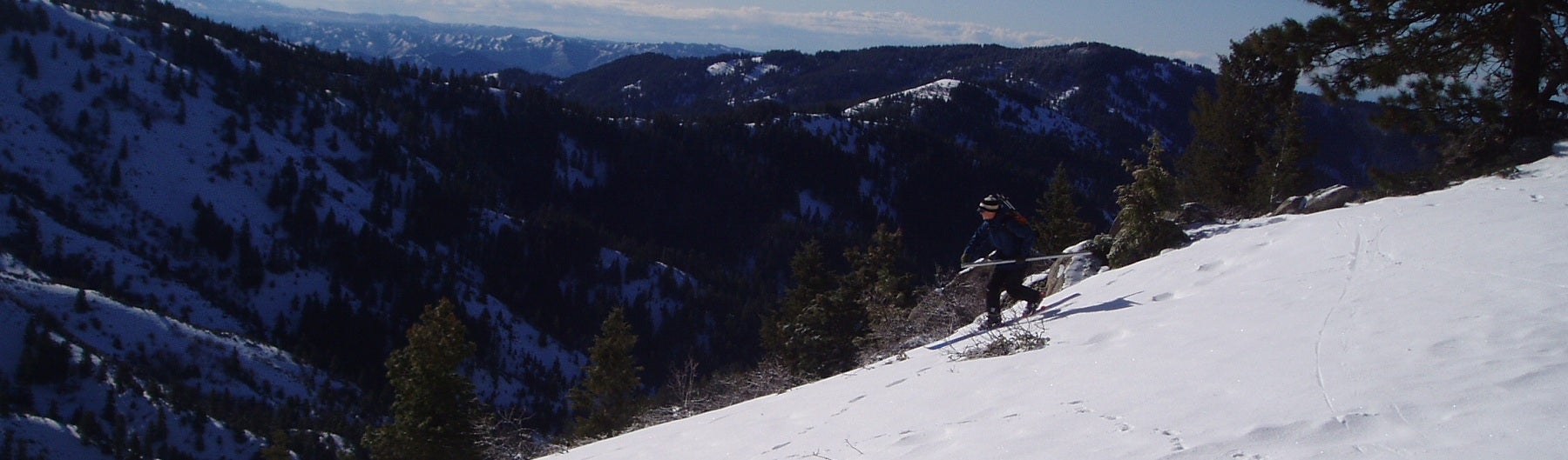 A researcher hikes down a snowy slope.