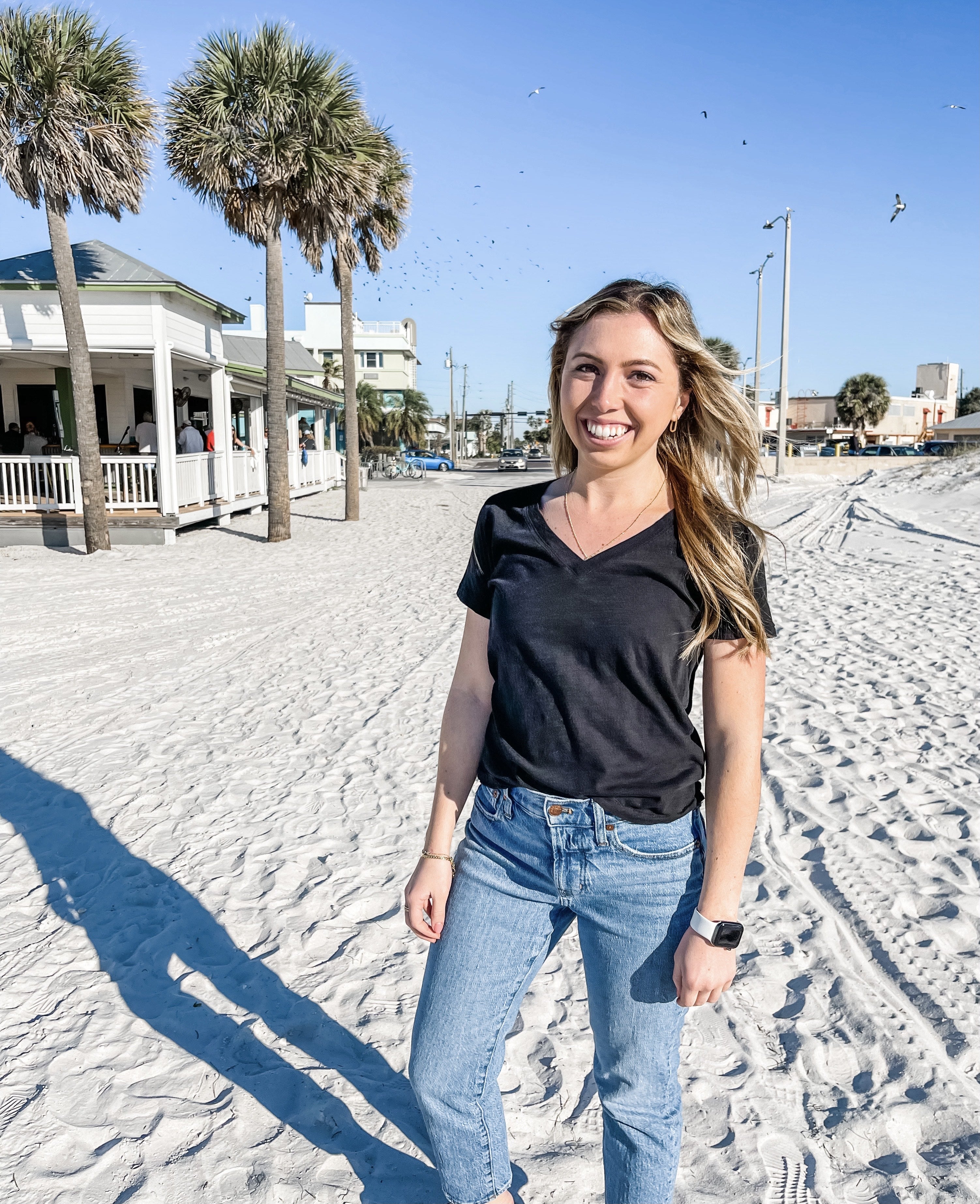 TRIO Teacher Prep student Megan Welter on a beach with palm trees