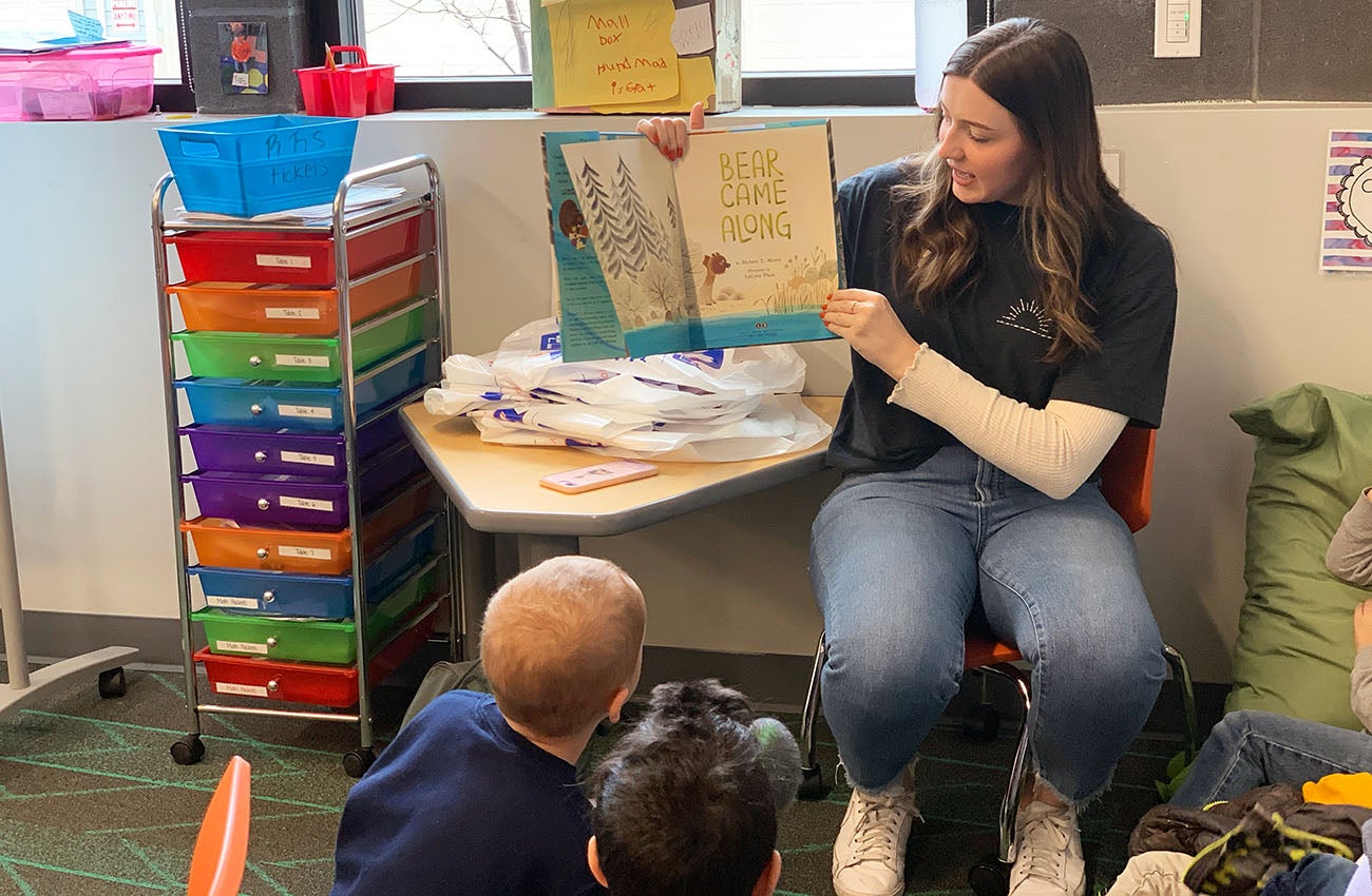 Carissa Schlachter reads a book to elementary students