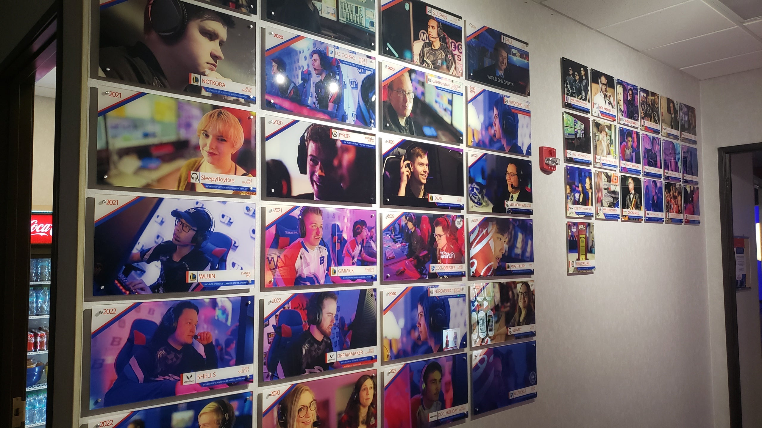 A photo of the Boise State Esports Hall of Fame. A large amount of plaques show various former students and what degree they graduated with.