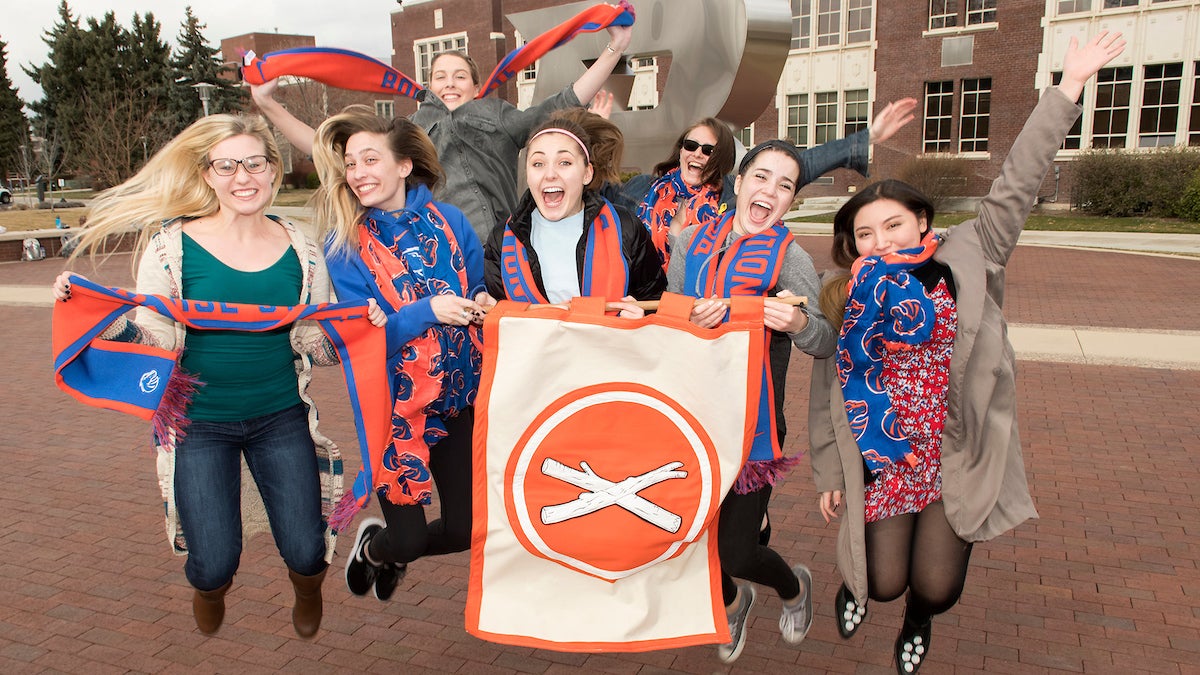 students jumping in front of the B
