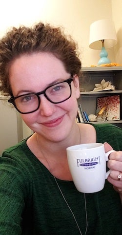 Huebschmann celebrates the close of the 2019 Fulbright cycle, posing with a memento from her time in Norway.