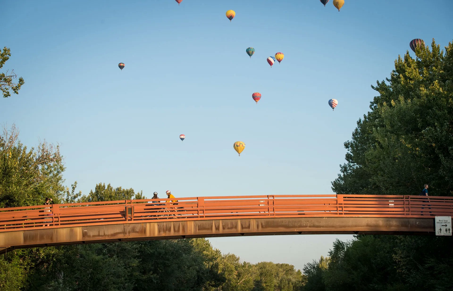 friendship bridge with bikers and hot air balloons