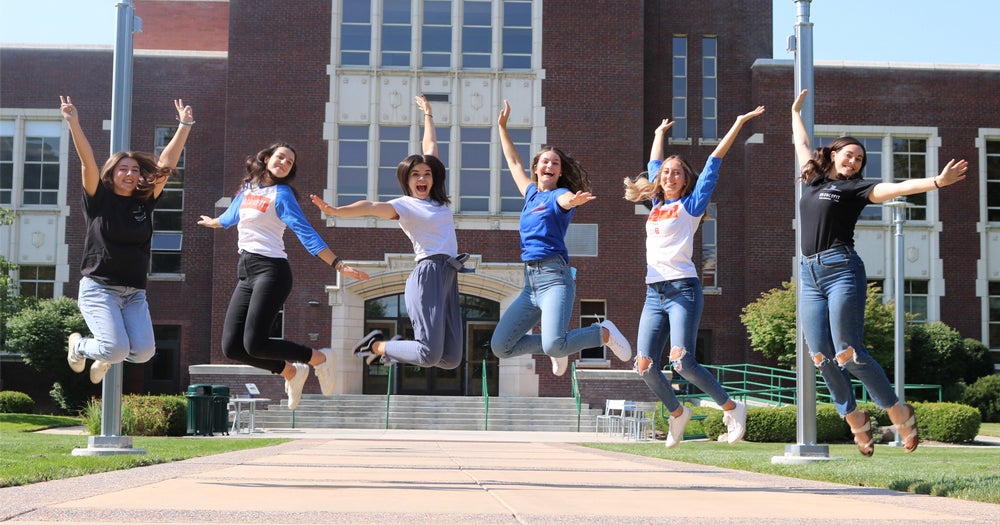Boise State Broncos jumping in front of the admin building