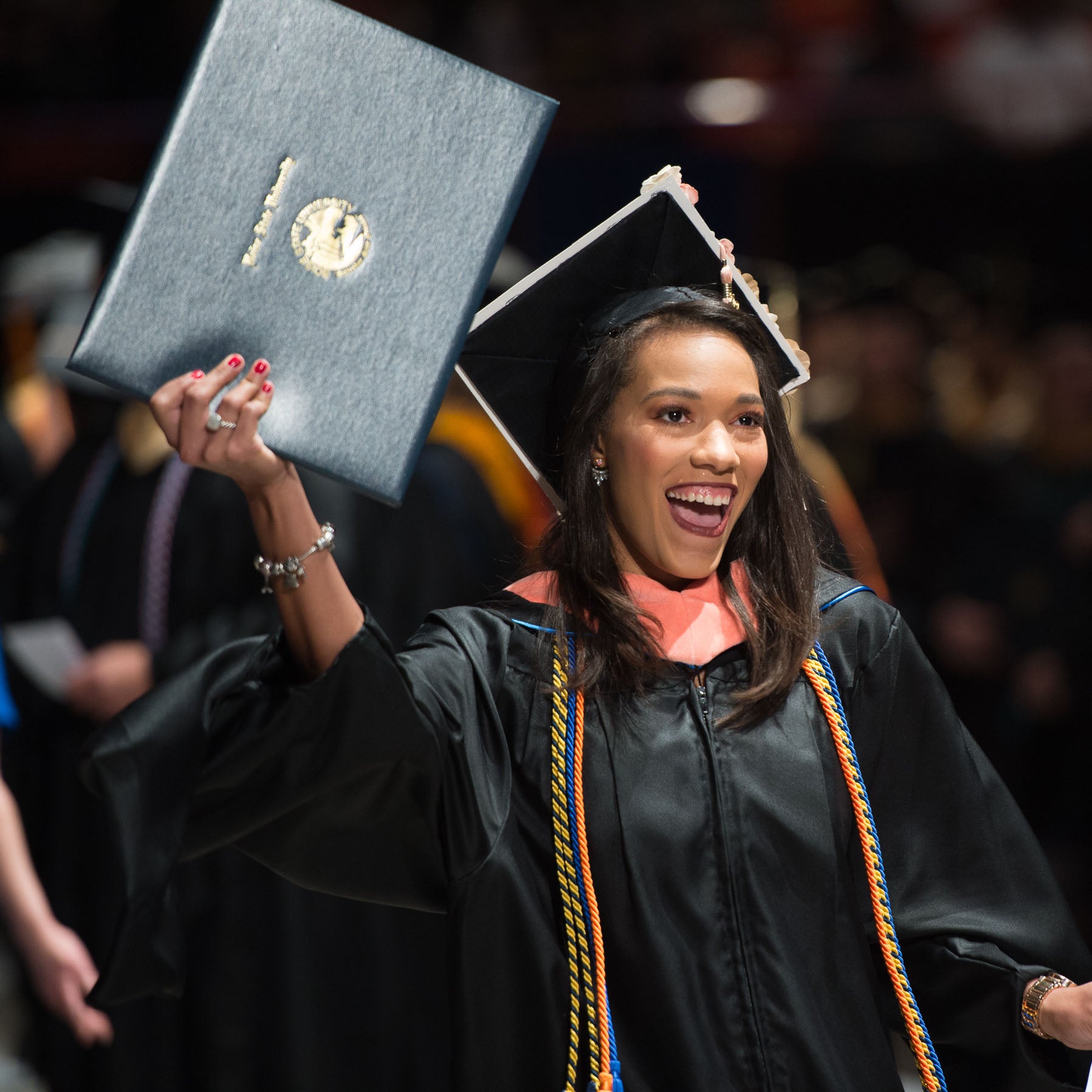 graduate student holding diploma