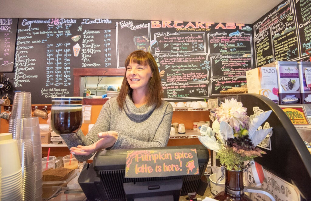 a woman holding a cup of coffee.