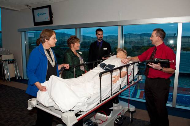 Phil Jimenez and Luther Raechal demonstrate simulation manikins to 2011 Friends of Nursing gala attendees.