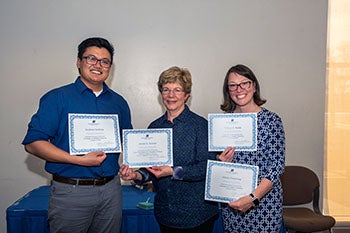 Student Andrew Nutting, professor Caile Spear, and student Tiffany A. Robb posing with awards