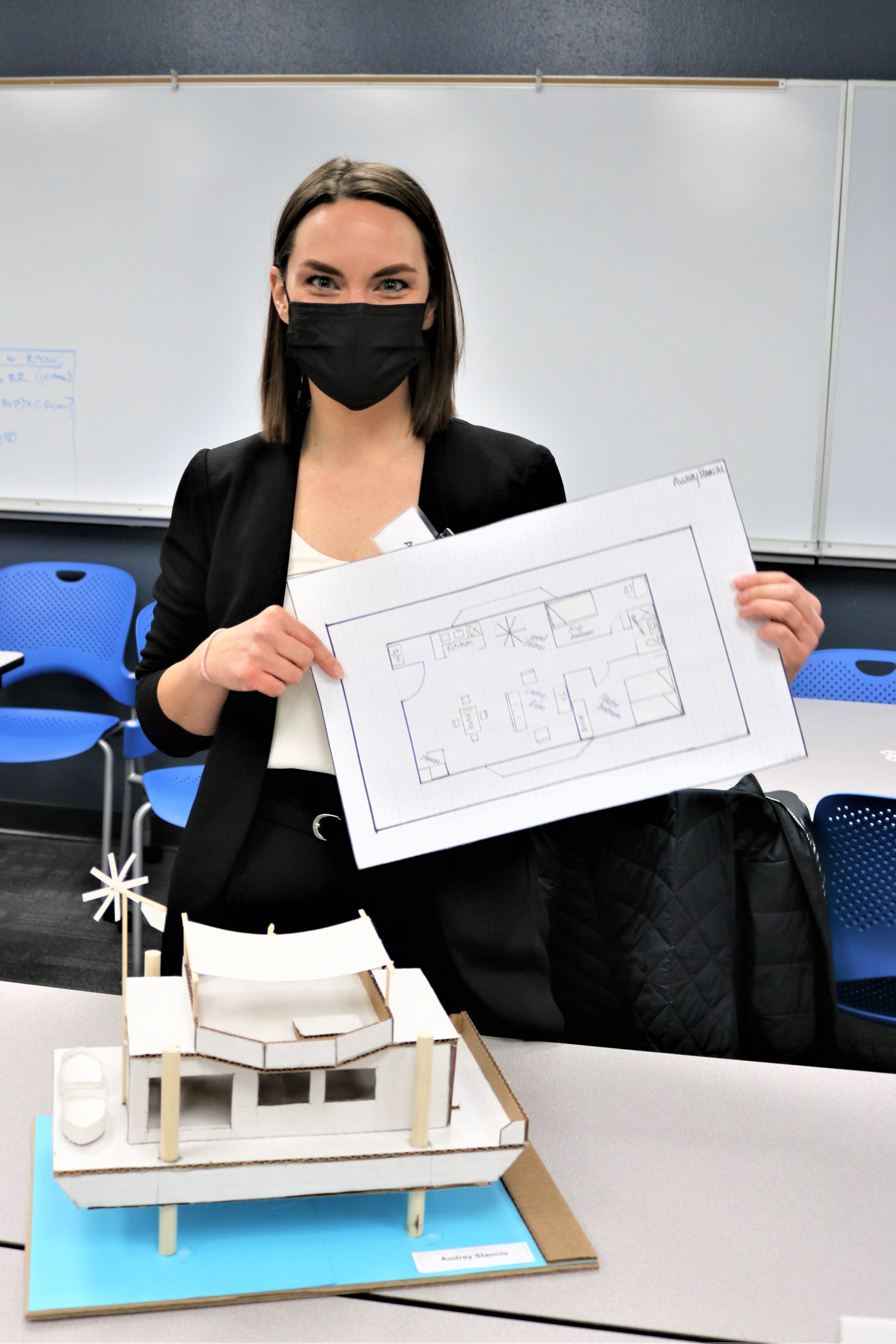 Stiancu holds paper model of design