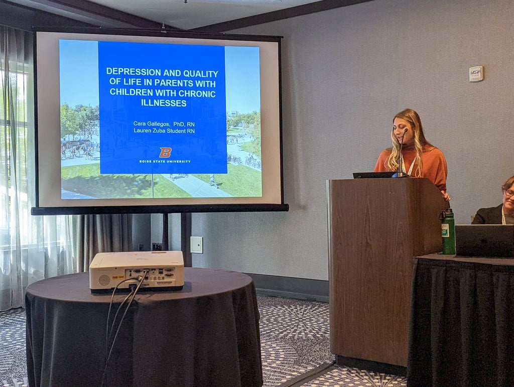 Nursing student Lauren Zuba gives a podium presentation titled "Depression and Quality of Life in Parents with Children with Chronic Illnesses".